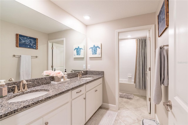 bathroom with shower / tub combo with curtain, vanity, and tile patterned flooring