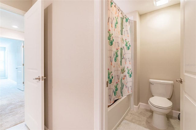 bathroom with shower / bath combo and toilet