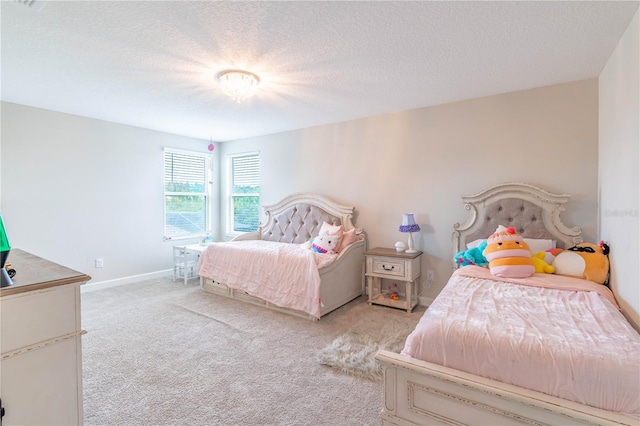 bedroom with light carpet and a textured ceiling