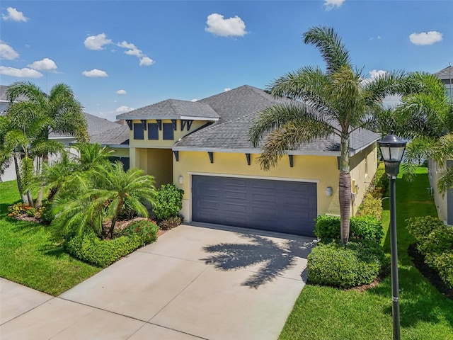 view of front of home featuring a garage and a front yard