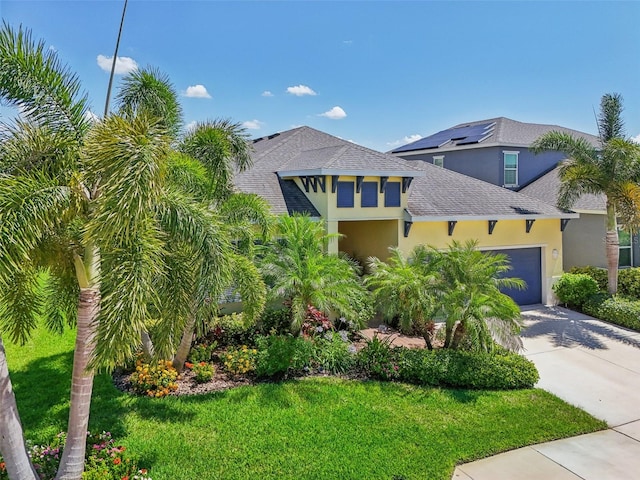 view of front facade with a front lawn and a garage