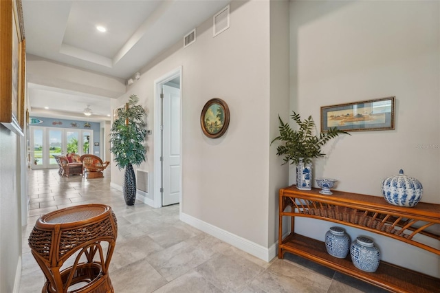 hallway with a raised ceiling