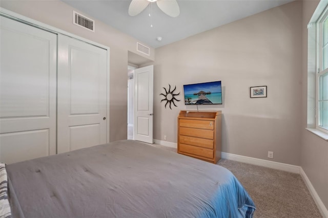 bedroom with carpet flooring, ceiling fan, and a closet