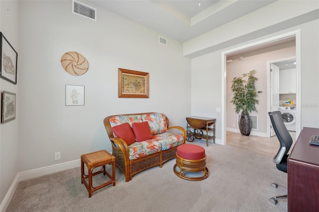 home office featuring light carpet and washer / dryer