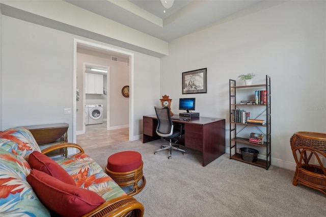 carpeted office space featuring washer / dryer