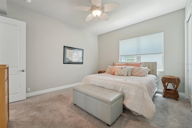 bedroom with ceiling fan and light colored carpet