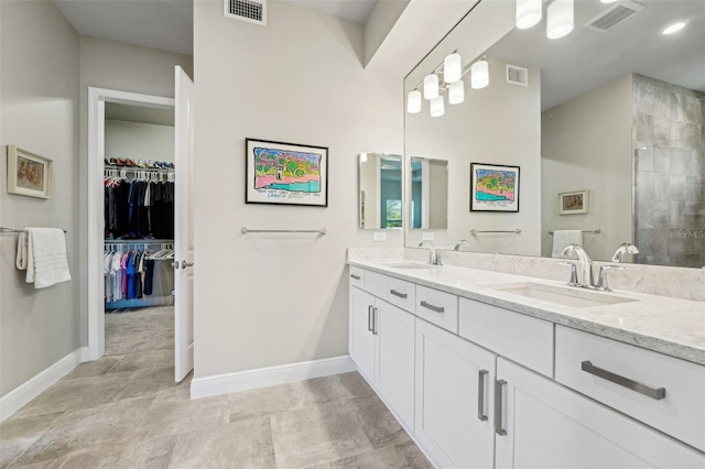 bathroom with vanity and a tile shower