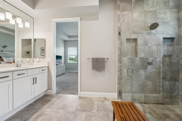 bathroom featuring tile patterned flooring, a shower with door, and vanity