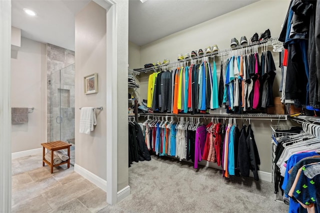 walk in closet with carpet floors