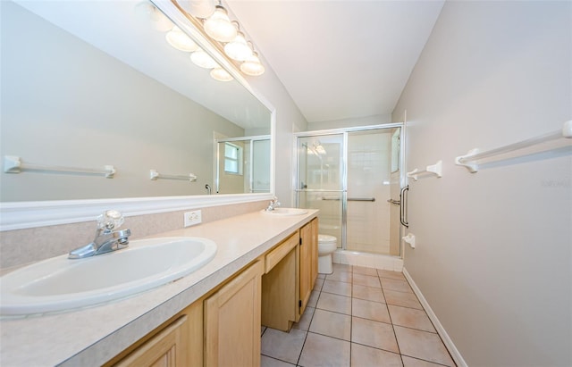 bathroom featuring tile patterned flooring, vanity, toilet, and walk in shower