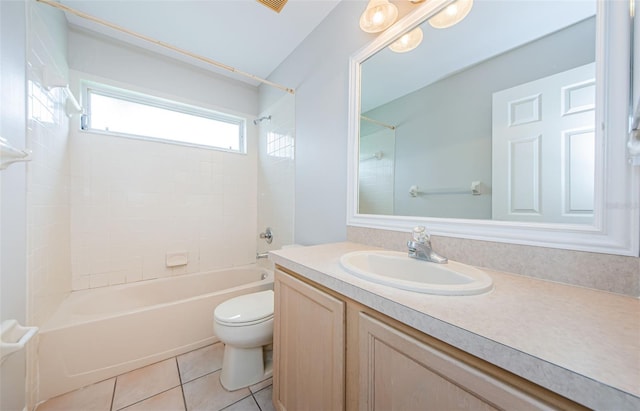 full bathroom with tiled shower / bath, vanity, tile patterned floors, and toilet