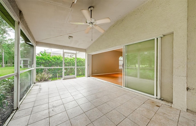 unfurnished sunroom featuring ceiling fan and lofted ceiling