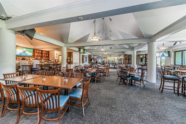 carpeted dining room featuring vaulted ceiling and ornamental molding