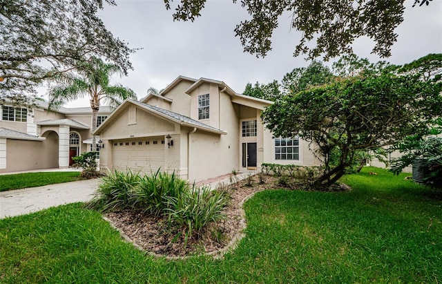 view of front of house with a garage and a front yard