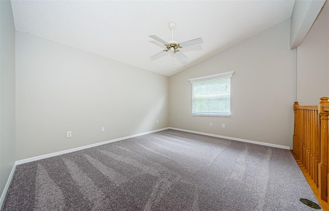 carpeted spare room featuring vaulted ceiling and ceiling fan