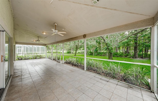 unfurnished sunroom with ceiling fan