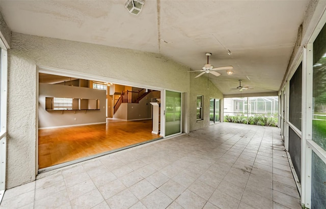 unfurnished sunroom featuring lofted ceiling