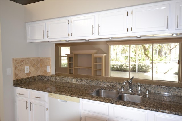 kitchen with sink, white cabinets, white dishwasher, and dark stone counters