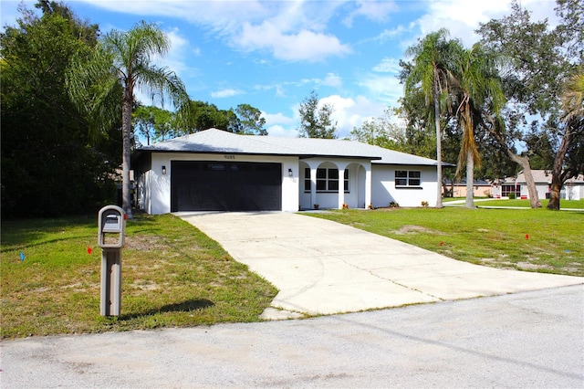 ranch-style house featuring a front lawn and a garage