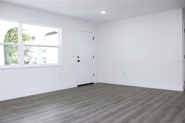 unfurnished room with dark hardwood / wood-style floors