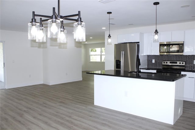 9085 Dorsey St, Spring Hill, FL 34608 - kitchen with stainless steel appliances, a sink, modern cabinets, white cabinets, and recessed lighting