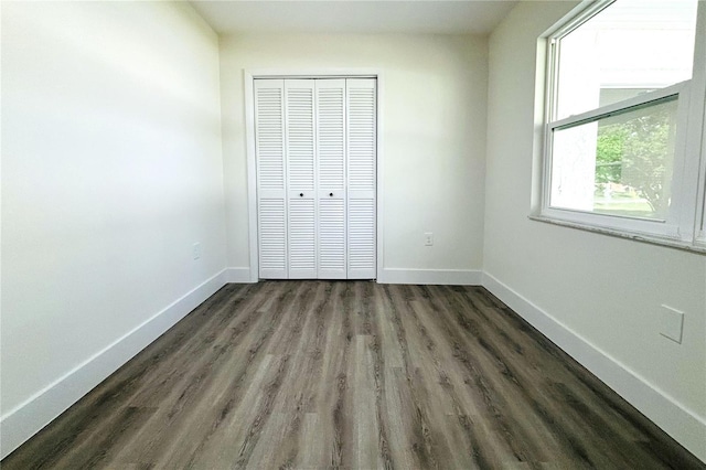 9085 Dorsey St, Spring Hill, FL 34608 - unfurnished bedroom featuring dark wood-type flooring, a closet, and baseboards
