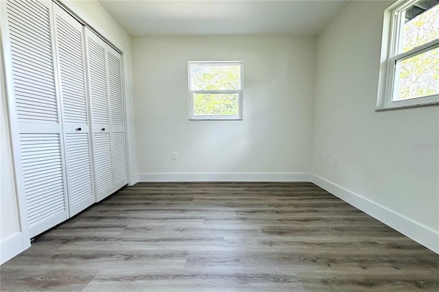 9085 Dorsey St, Spring Hill, FL 34608 - unfurnished bedroom featuring a closet, baseboards, and wood finished floors