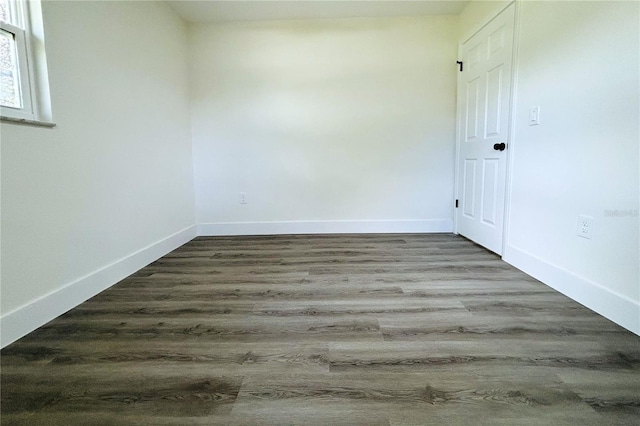 empty room with dark wood-type flooring