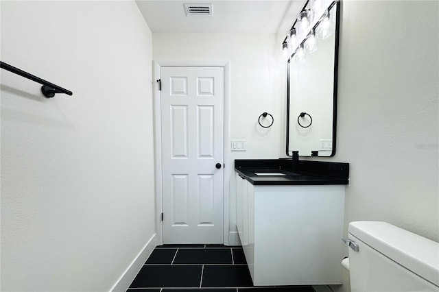 9085 Dorsey St, Spring Hill, FL 34608 - bathroom with tile patterned floors, toilet, vanity, and baseboards
