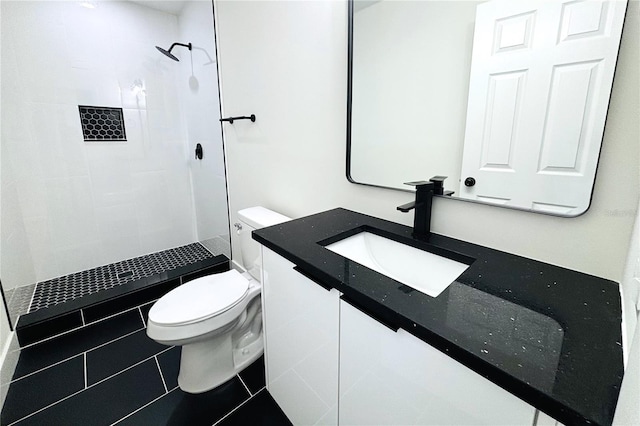 9085 Dorsey St, Spring Hill, FL 34608 - bathroom with toilet, vanity, a tile shower, and tile patterned floors