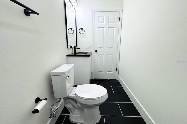 bathroom featuring sink, tile patterned floors, and toilet