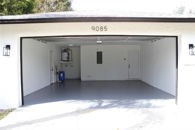 garage featuring water heater and electric panel