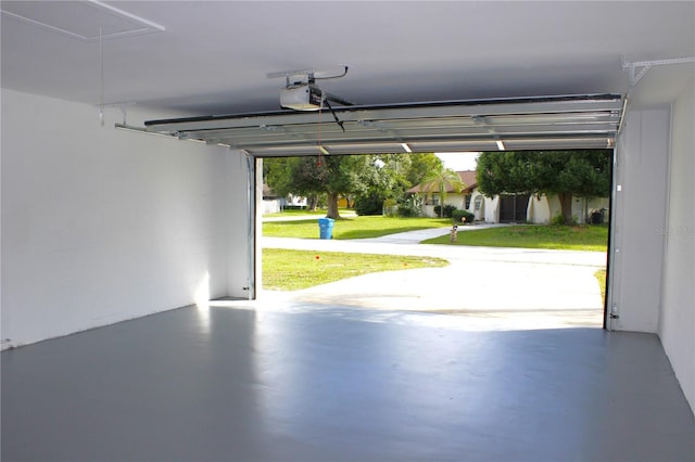 garage with a garage door opener and a yard