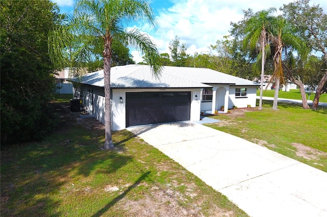 single story home featuring a front lawn and a garage