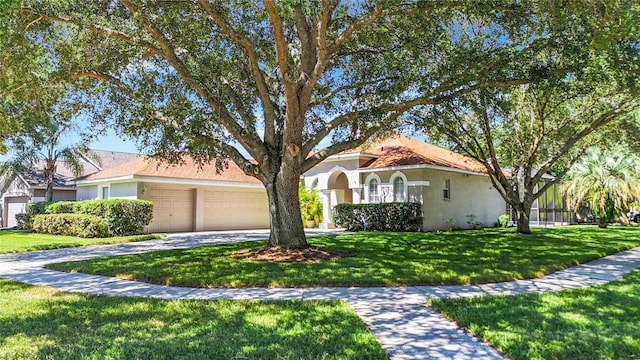 view of front of house featuring a front lawn and a garage