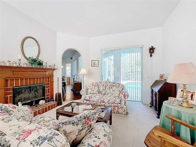 carpeted living room featuring a fireplace