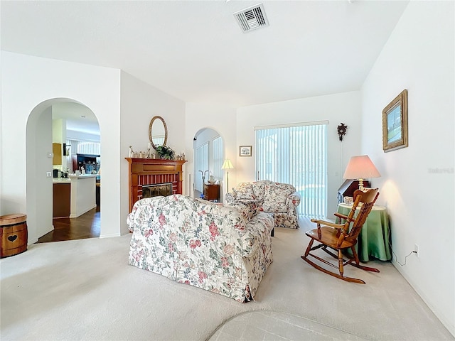 living room with a fireplace and carpet