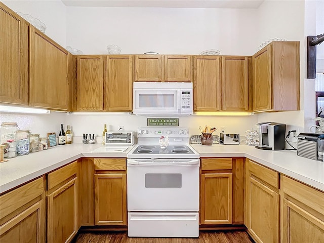 kitchen featuring dark hardwood / wood-style flooring and white appliances