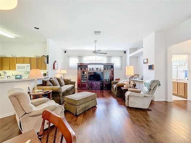 living room with ceiling fan and hardwood / wood-style flooring