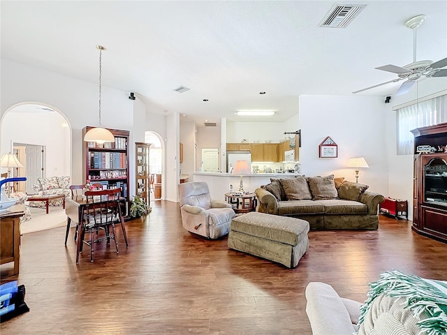 living room with ceiling fan and dark wood-type flooring