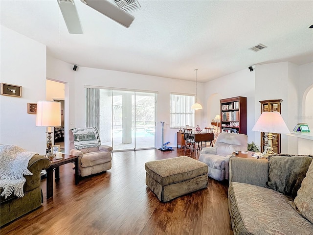 living room featuring ceiling fan and hardwood / wood-style flooring