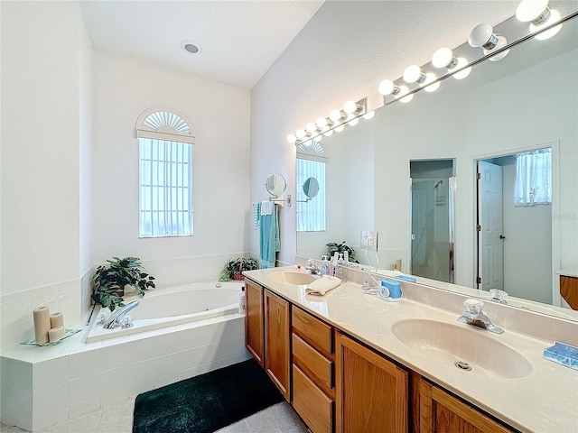 bathroom with shower with separate bathtub and vanity