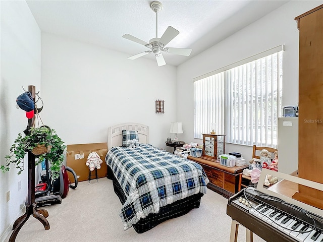 carpeted bedroom featuring a textured ceiling and ceiling fan