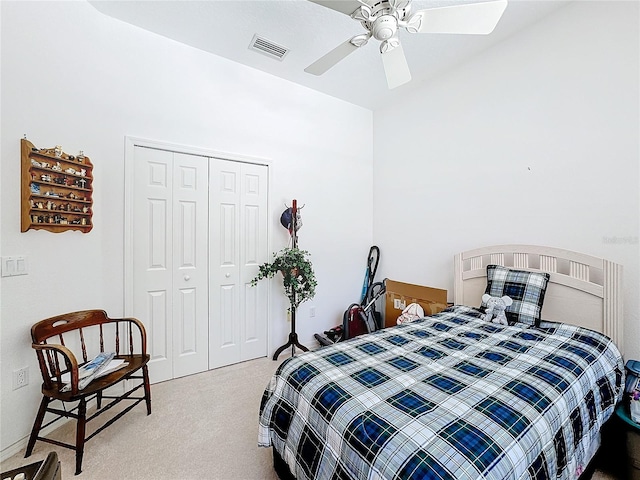 bedroom featuring a closet, light colored carpet, and ceiling fan