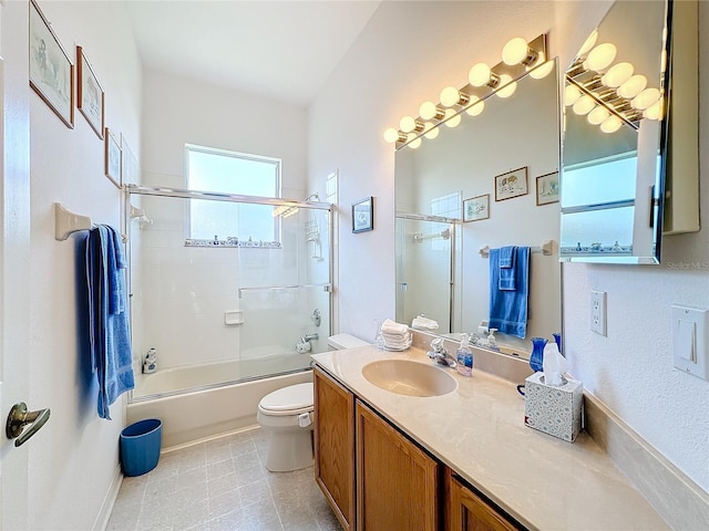 full bathroom featuring shower / bath combination with glass door, vanity, and toilet