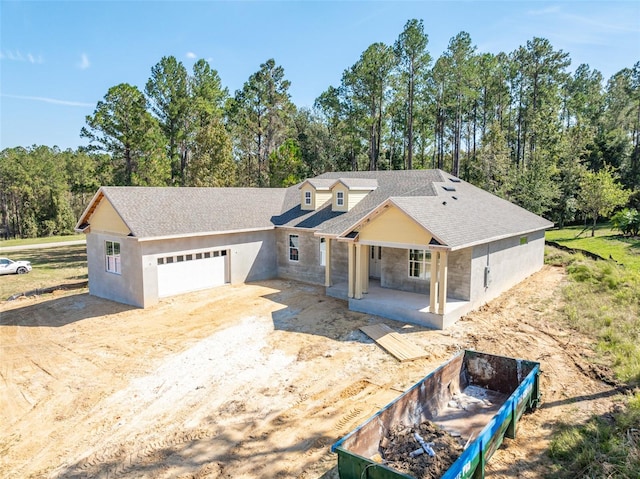 view of front of property featuring a porch and a garage