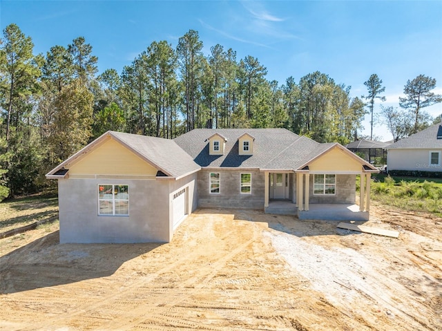 view of front of property with a porch and a garage