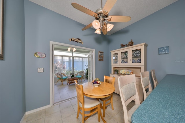 dining area featuring a textured ceiling, light tile patterned flooring, and ceiling fan