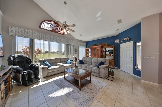 living room featuring ceiling fan, light tile patterned floors, and high vaulted ceiling