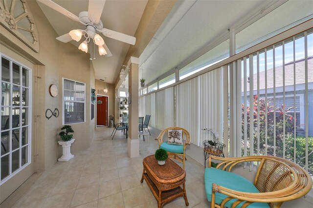 sunroom featuring ceiling fan and lofted ceiling